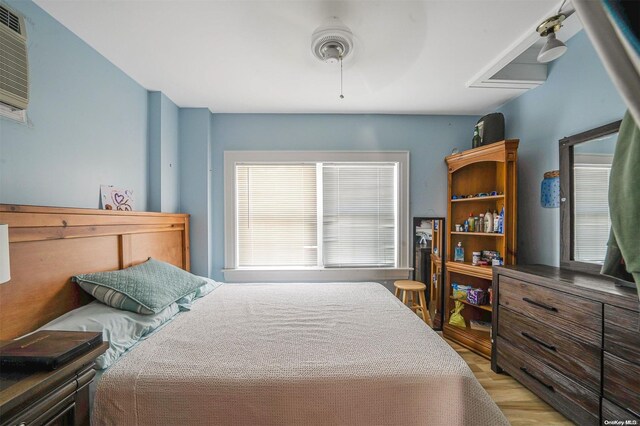 bedroom featuring multiple windows, ceiling fan, and light hardwood / wood-style flooring