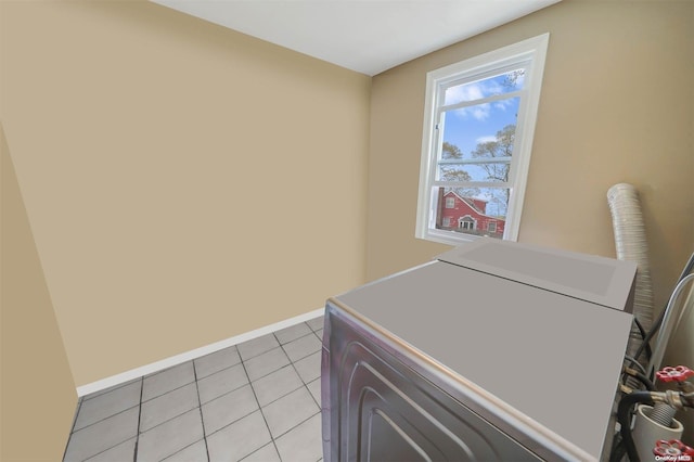 laundry area with light tile patterned floors and washer and dryer