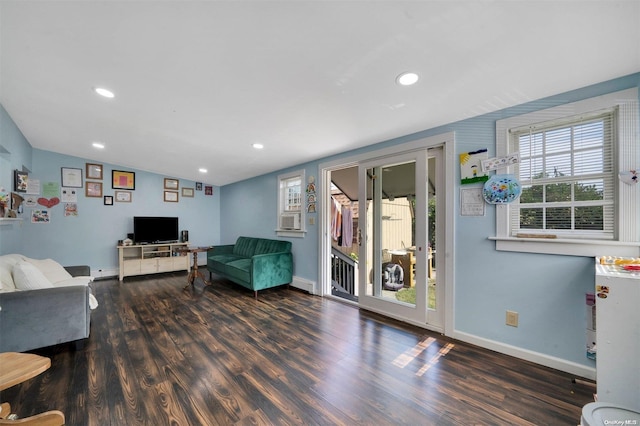 living room with dark hardwood / wood-style floors, a baseboard heating unit, and vaulted ceiling