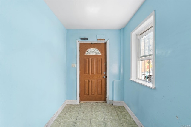 doorway with light tile patterned floors