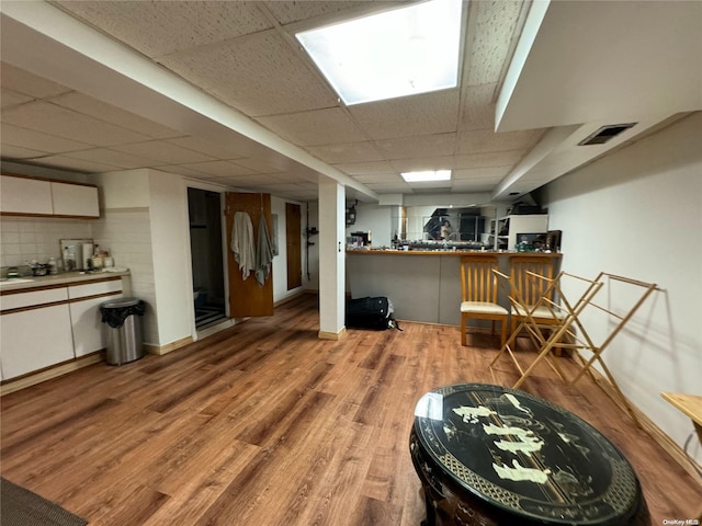 interior space featuring light hardwood / wood-style flooring and a drop ceiling