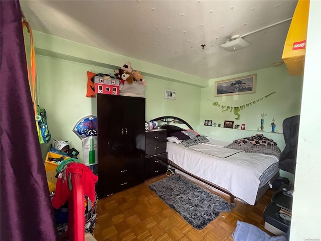 bedroom featuring parquet flooring