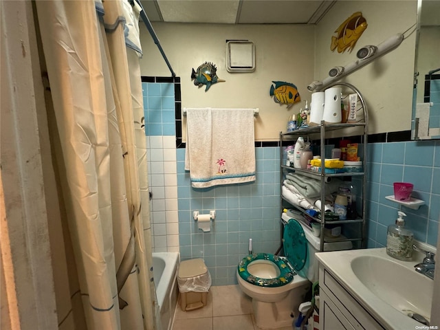 full bathroom featuring vanity, tile patterned flooring, toilet, shower / bath combo with shower curtain, and tile walls