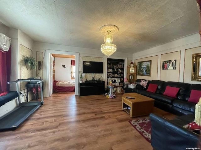 living room featuring hardwood / wood-style floors, a chandelier, and a textured ceiling