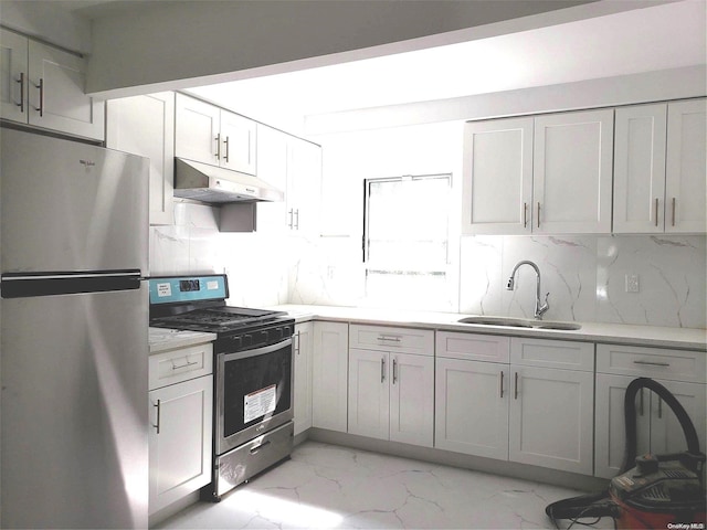 kitchen with tasteful backsplash, white cabinetry, sink, and stainless steel appliances