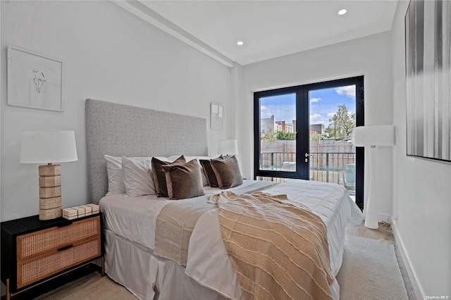 bedroom with light hardwood / wood-style flooring, access to outside, and french doors