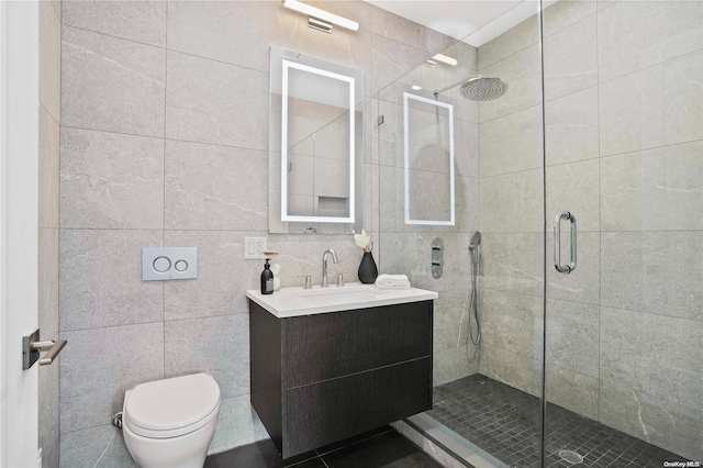 bathroom with an enclosed shower, vanity, toilet, and tile walls