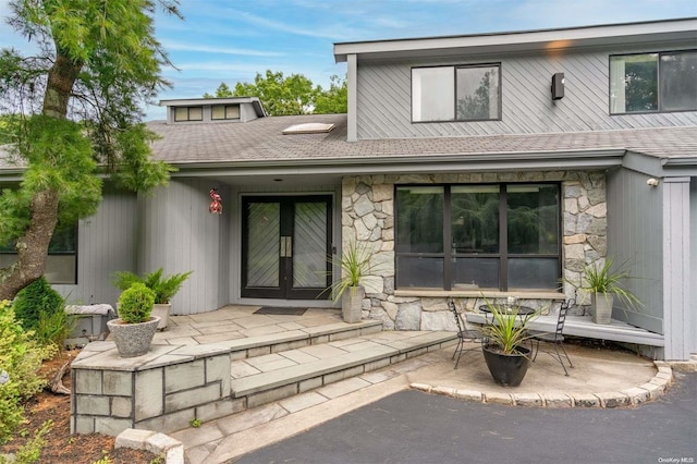 back of property with french doors and a patio