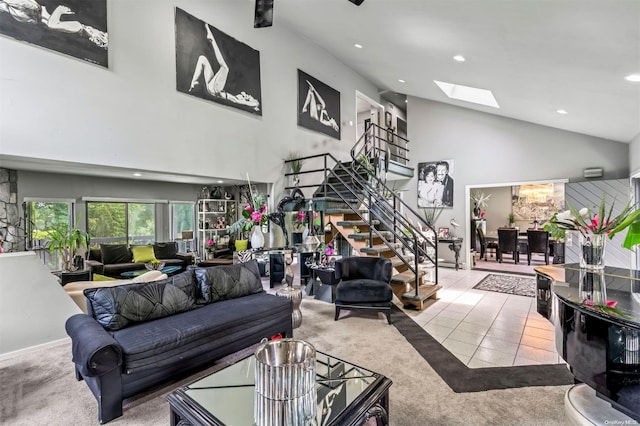 living room featuring light carpet, high vaulted ceiling, and a skylight