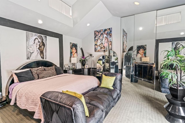 carpeted bedroom featuring high vaulted ceiling