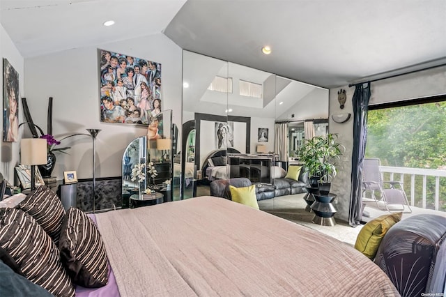 bedroom with vaulted ceiling and multiple windows