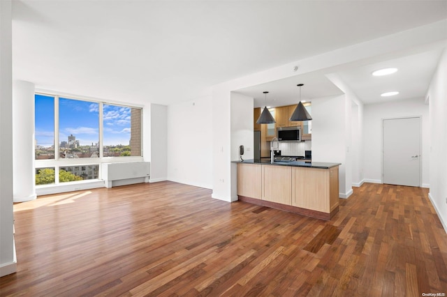 kitchen featuring pendant lighting, dark hardwood / wood-style floors, light brown cabinets, and sink