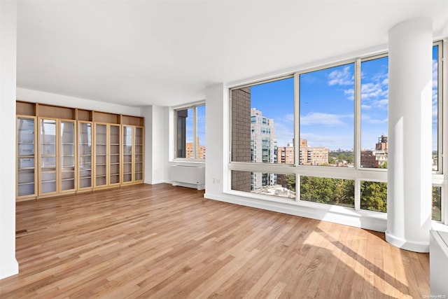 interior space featuring expansive windows and light hardwood / wood-style flooring