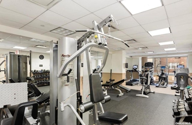 exercise room featuring a paneled ceiling