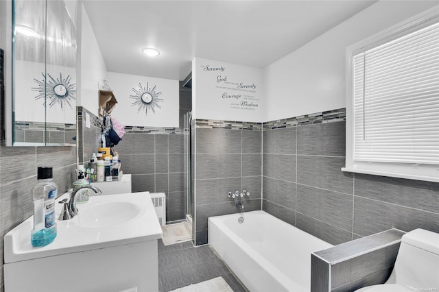 bathroom with toilet, tile walls, and a tub