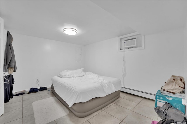 tiled bedroom with a wall unit AC and a baseboard radiator