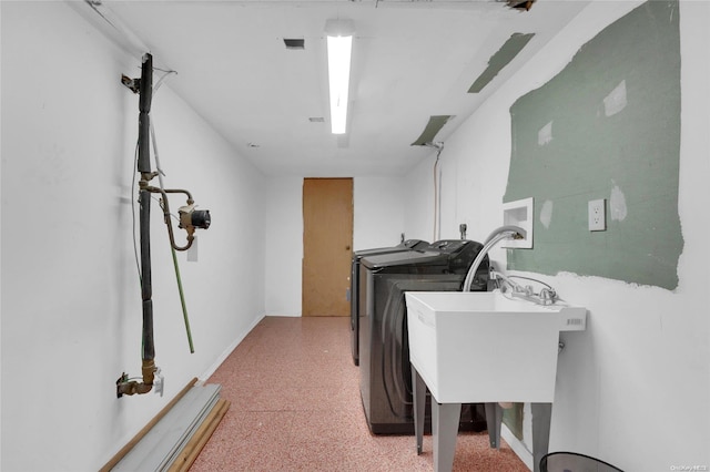 laundry room with washer and clothes dryer and sink