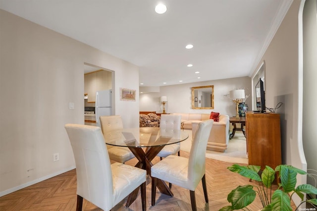 dining area featuring crown molding and light parquet flooring