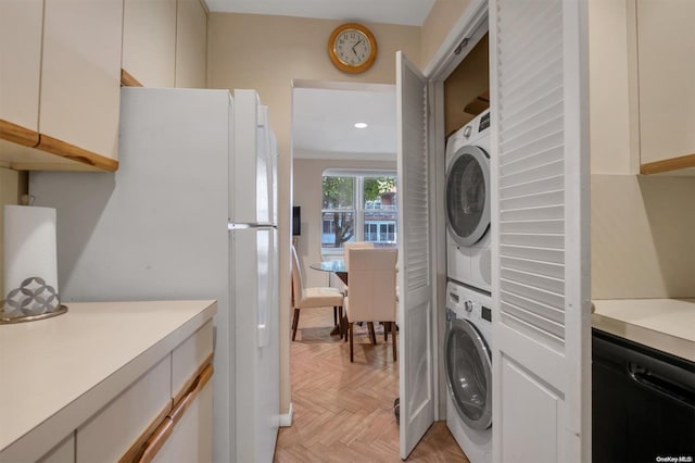 washroom with stacked washing maching and dryer, ornamental molding, and light parquet flooring