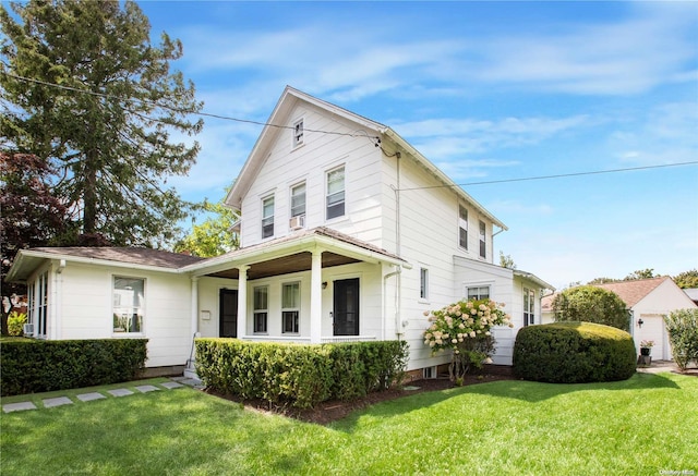 view of front of property with covered porch and a front lawn