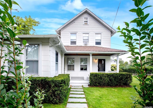 bungalow featuring a front yard and covered porch