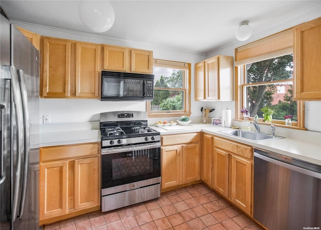 kitchen with light tile patterned floors, stainless steel appliances, and sink