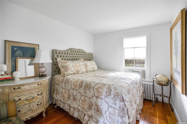 bedroom with radiator heating unit and dark wood-type flooring