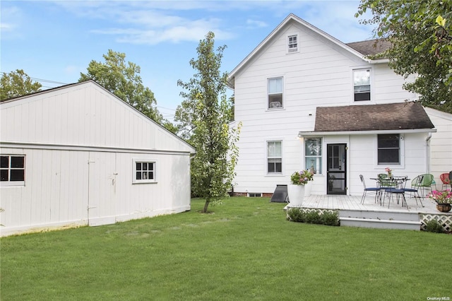 rear view of property with a yard and a deck