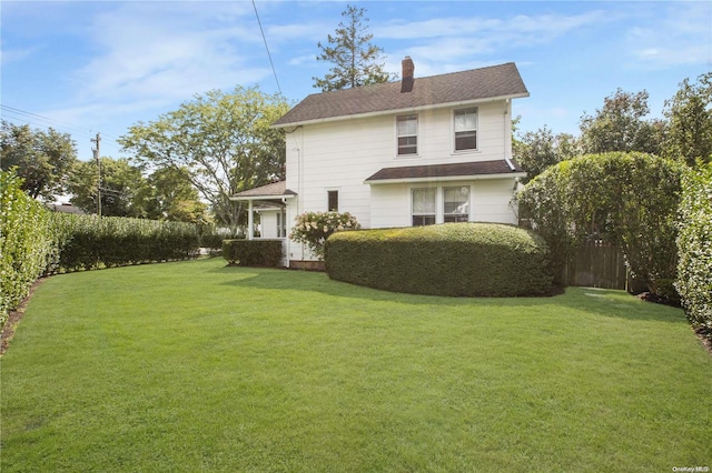 back of house featuring a yard