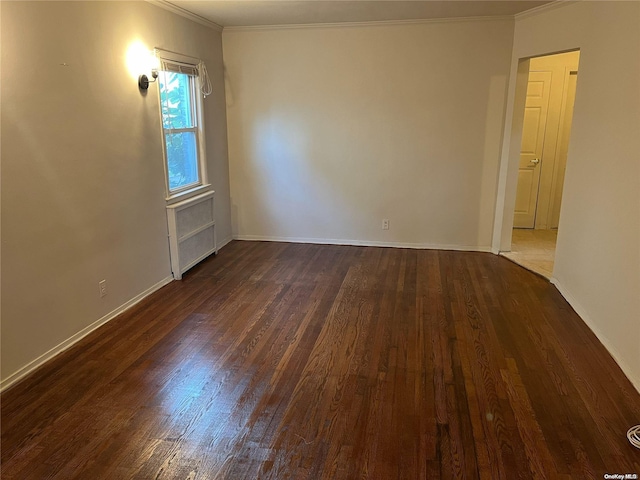 unfurnished room featuring radiator, dark hardwood / wood-style flooring, and ornamental molding