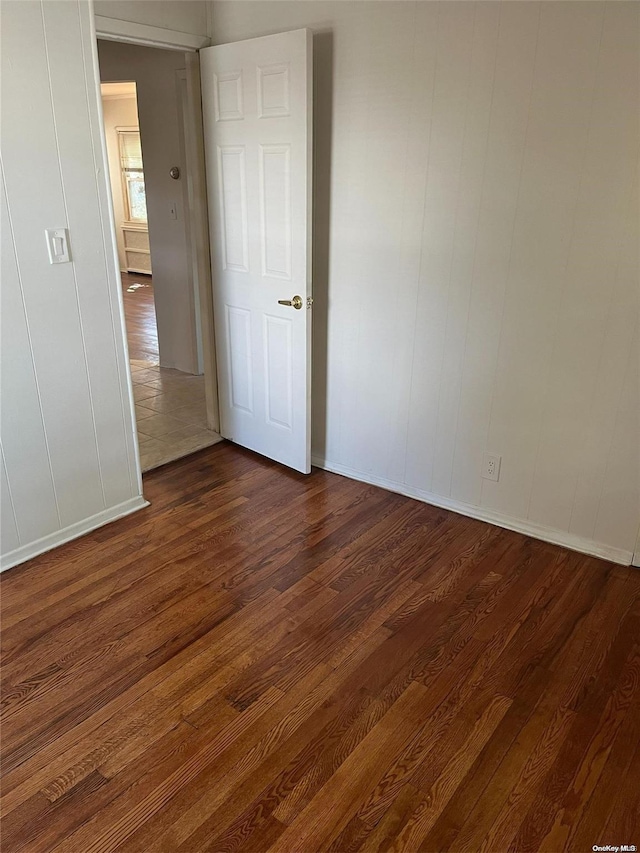 spare room with dark hardwood / wood-style floors