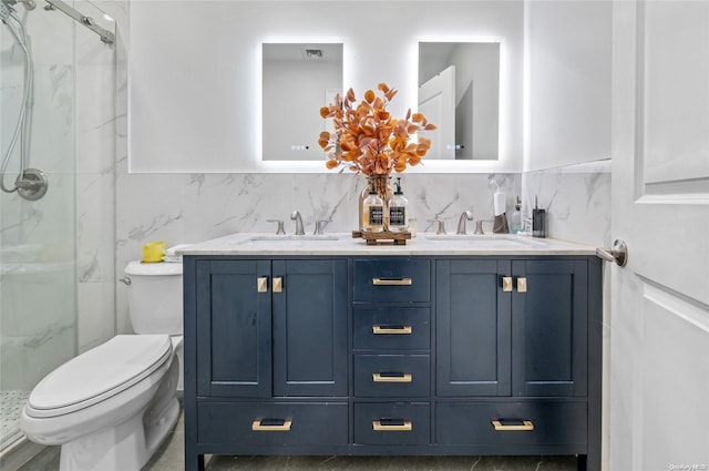 bathroom with a shower with door, vanity, and toilet