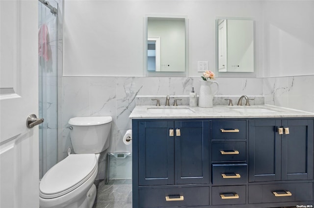 bathroom with vanity, tile walls, and toilet