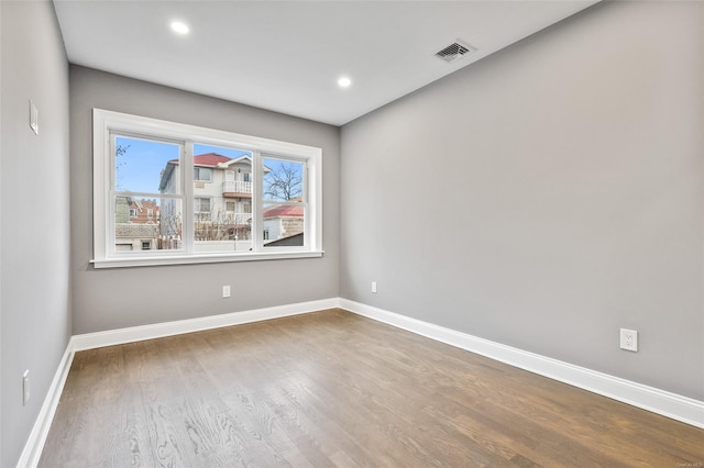 unfurnished room featuring hardwood / wood-style flooring