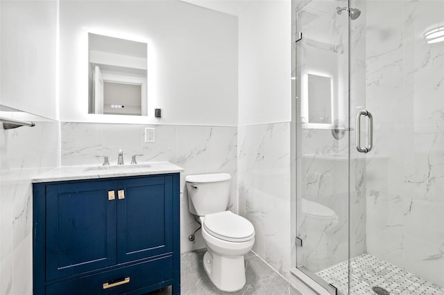 bathroom featuring an enclosed shower, vanity, toilet, and tile walls