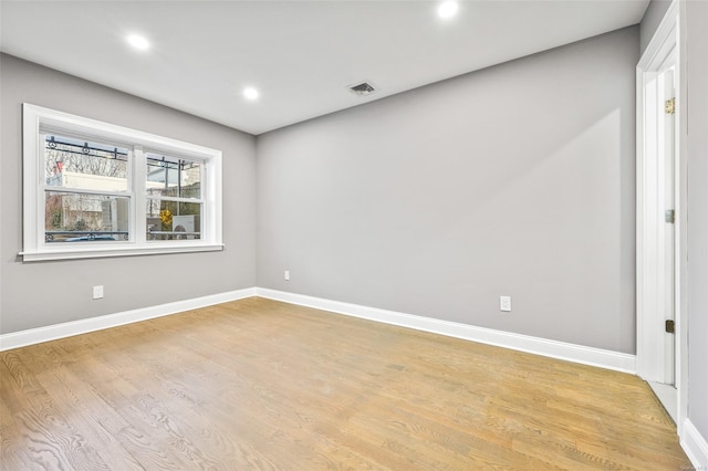 empty room with light hardwood / wood-style flooring