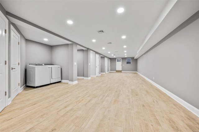 basement with light hardwood / wood-style floors