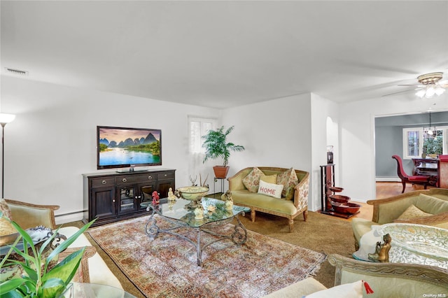 living room featuring ceiling fan and a baseboard heating unit