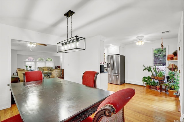 dining room featuring light hardwood / wood-style floors and ceiling fan