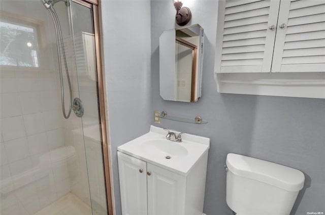 bathroom with vanity, toilet, and an enclosed shower