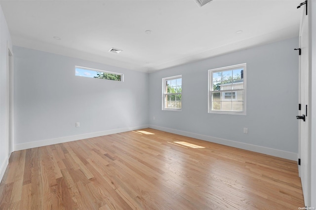 empty room with light hardwood / wood-style flooring