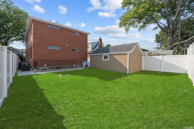 view of yard featuring a storage shed and central air condition unit