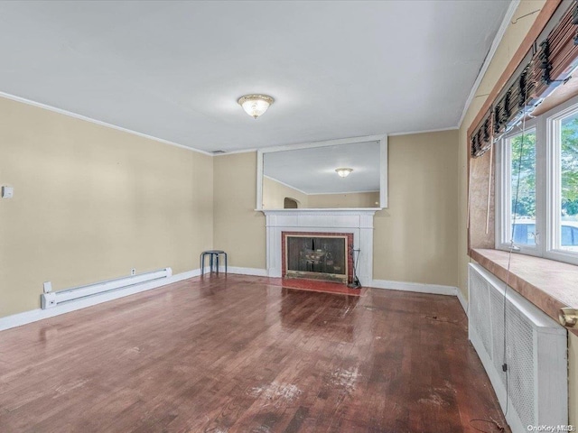 unfurnished living room with baseboard heating, crown molding, and hardwood / wood-style floors