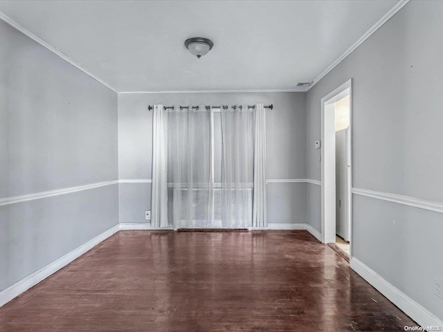 spare room with dark hardwood / wood-style flooring and ornamental molding