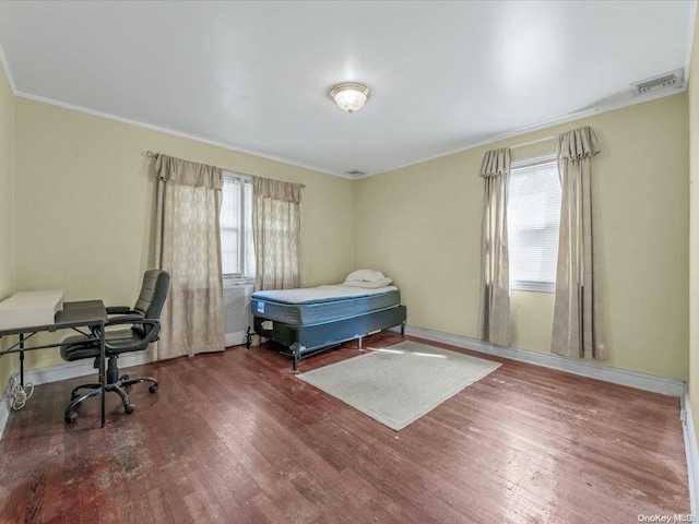 bedroom featuring dark hardwood / wood-style floors and ornamental molding