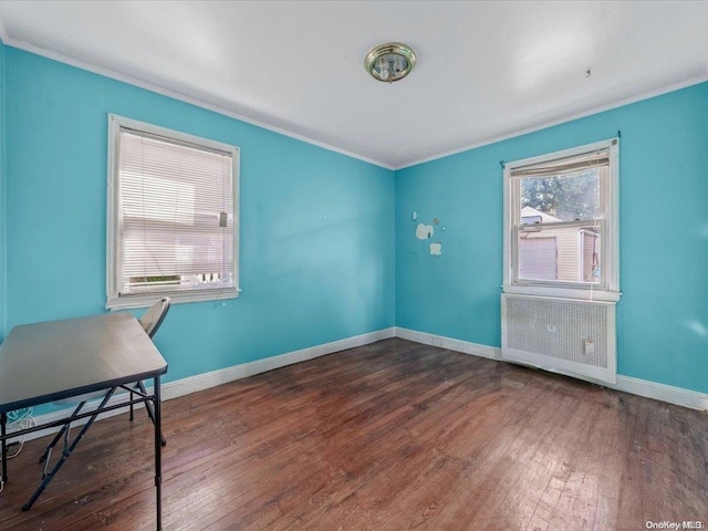 unfurnished office with crown molding and dark wood-type flooring