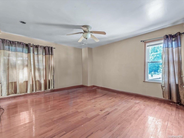 spare room featuring light hardwood / wood-style floors and ceiling fan