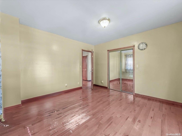 unfurnished room with hardwood / wood-style floors