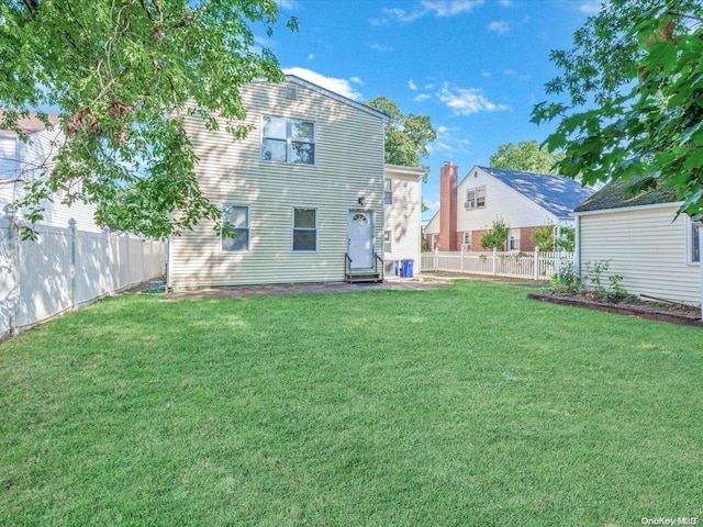 back of house featuring a lawn