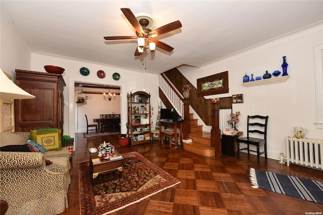 living room with ceiling fan, radiator heating unit, dark parquet floors, and crown molding